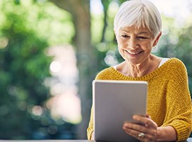 New to Medicare? Senior woman looking at iPad
