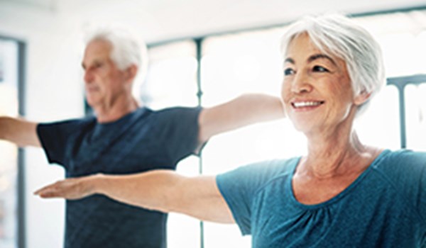 SilverSneakers® Program Senior couple practicing yoga