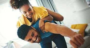 Dad with a daughter playing on his back